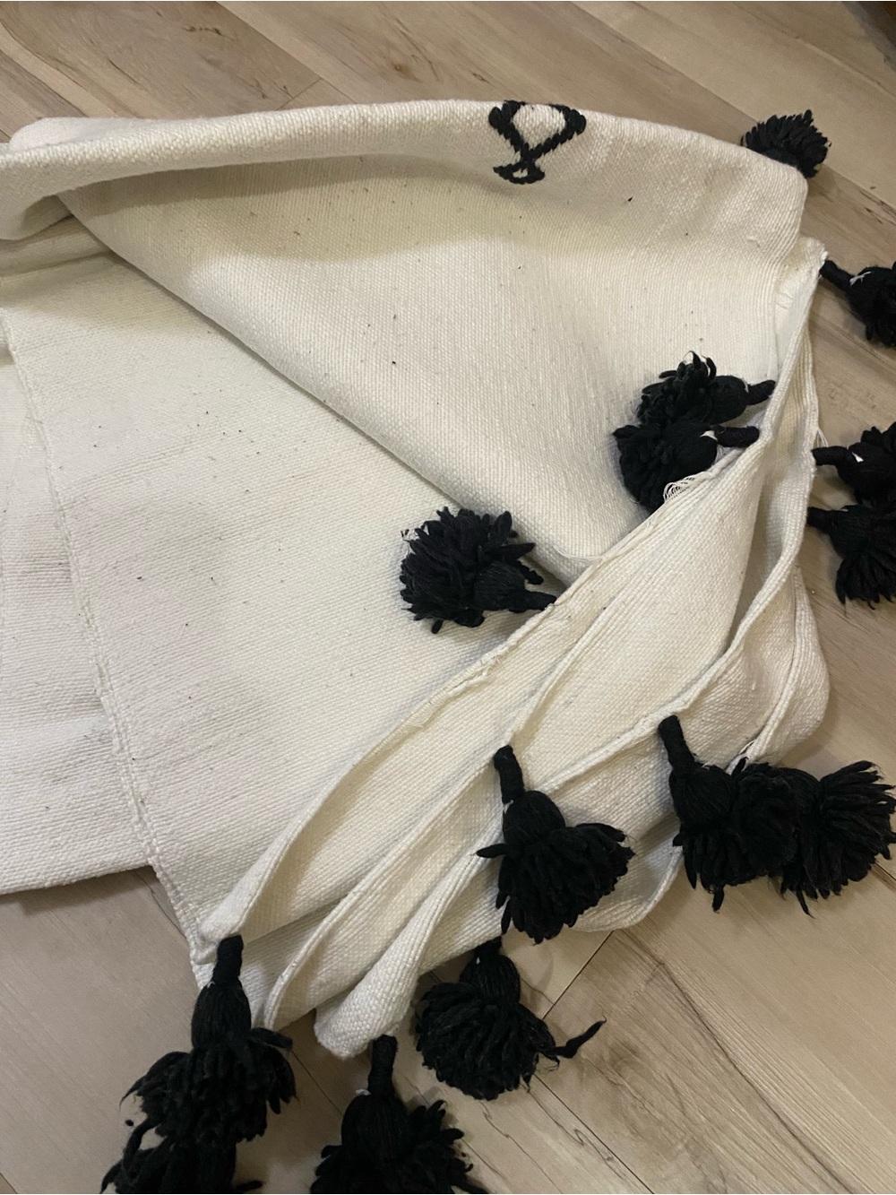 White and black moroccan Throw Blanket with Black Pom-Pom Accents